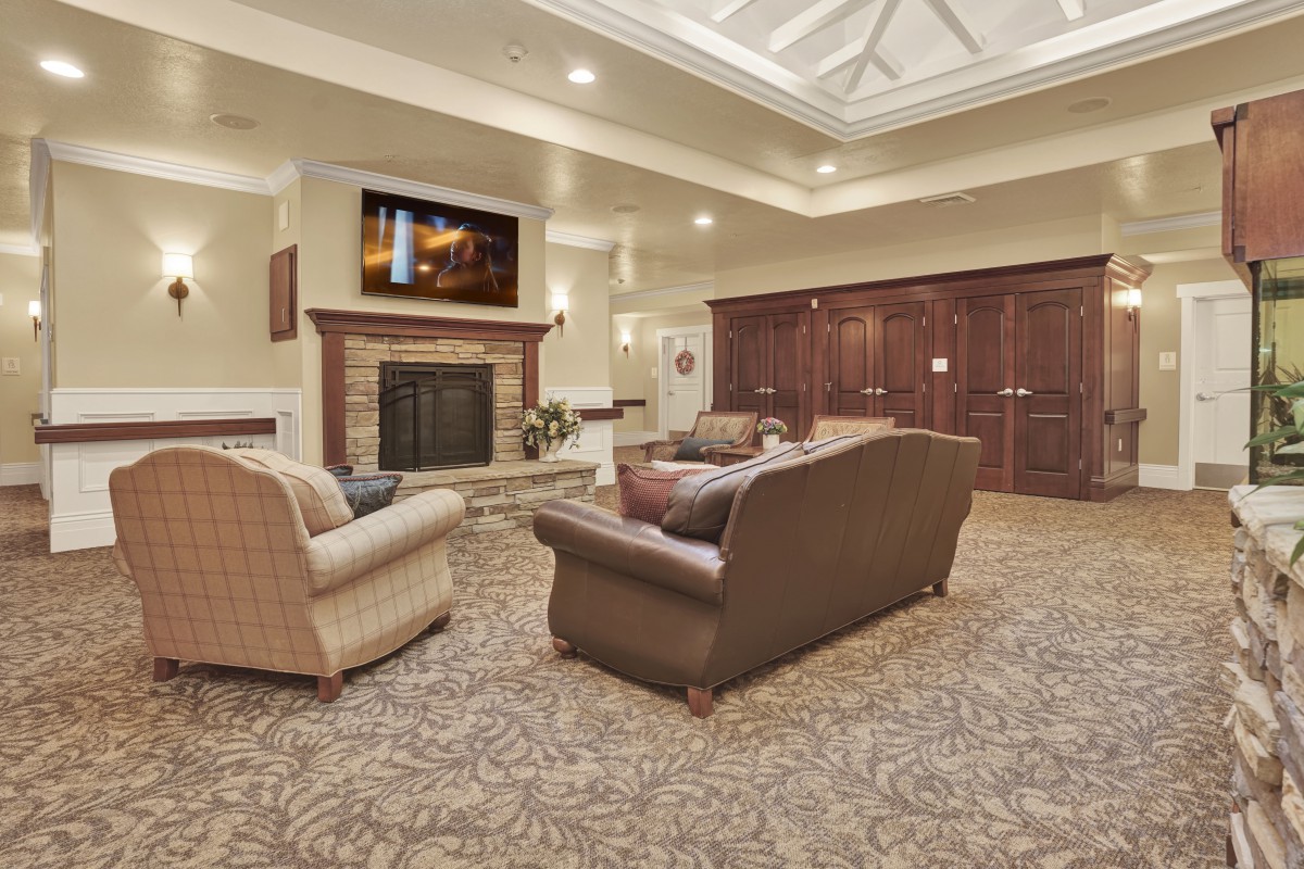 A cozy living room with a fireplace and seating area.