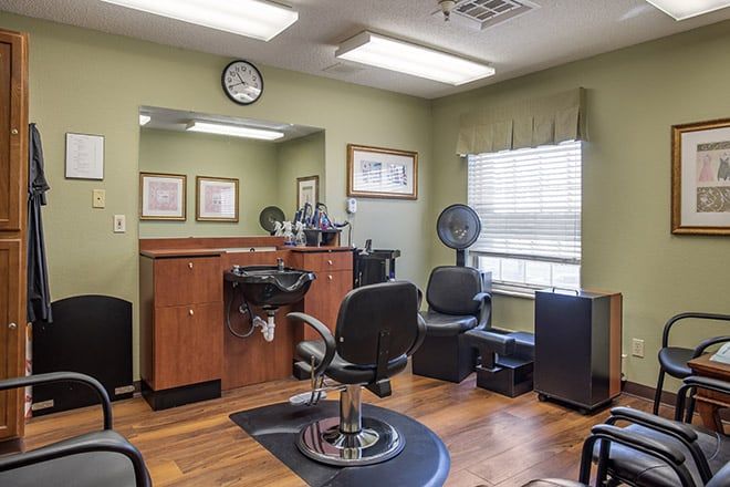 An inviting barber shop interior featuring a hairdressing station and comfortable seating.