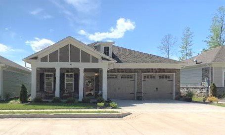 A suburban residential house with a two-car garage and a driveway.