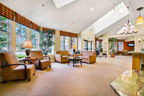 A spacious and well-lit lobby with comfortable seating, large windows, and tasteful decor.