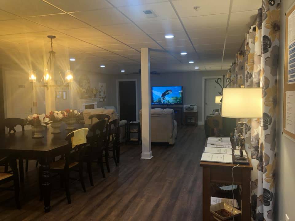 A cozy and modern living space featuring a dining area, a TV, and stylish lighting.