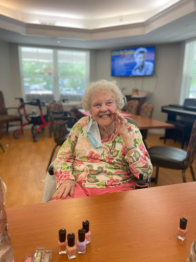 A cheerful elderly woman enjoying her time in a community center.