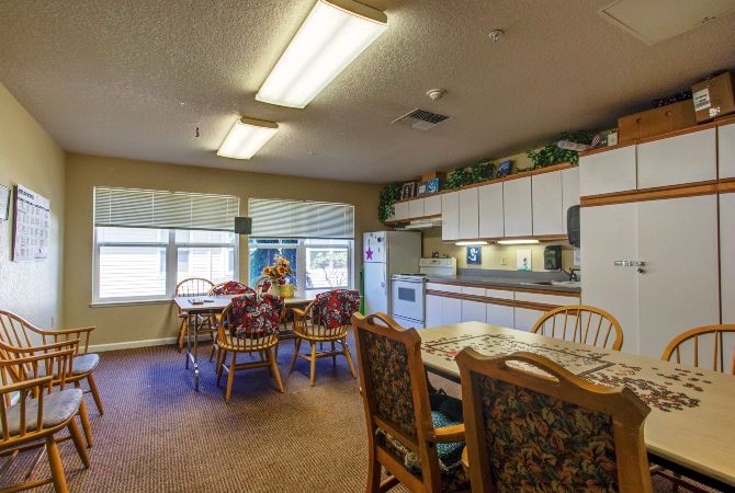 A cozy kitchen and dining area with wooden furniture and bright lighting.