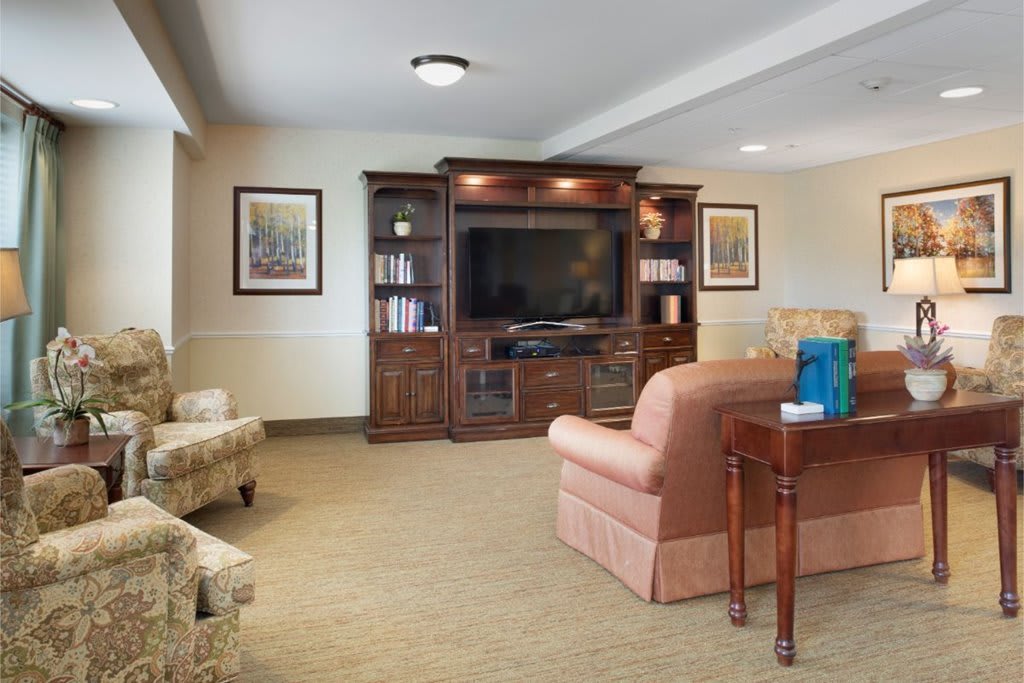 A cozy living room with a large entertainment center and comfortable seating.