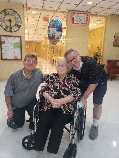 A heartwarming moment with family, celebrating together in a care facility.