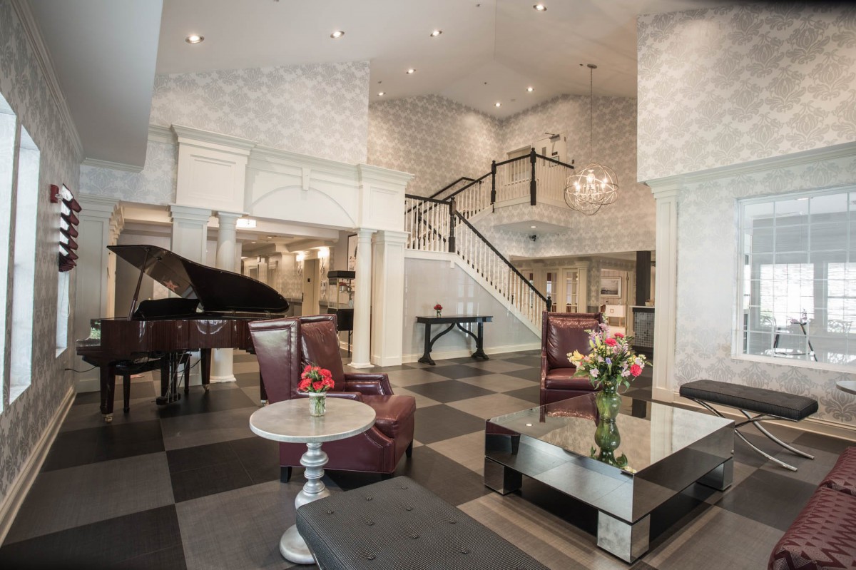 Elegant hotel lobby with a grand piano and stylish furnishings.