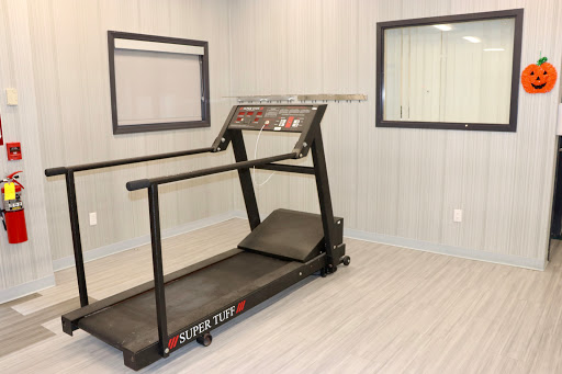 A treadmill ready for a workout session in a well-lit indoor space.
