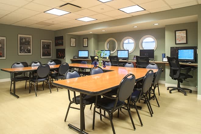 A spacious room equipped with computers and arranged for meetings or classes.