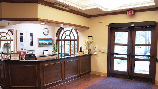 A welcoming reception area featuring a wooden front desk and elegant decor.