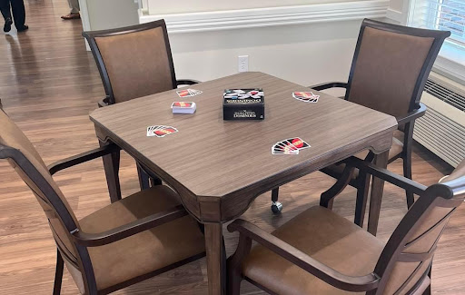 A cozy game setup with a square table and chairs, ready for some fun.