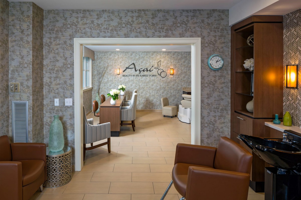A cozy and inviting salon waiting area with comfortable chairs and elegant decor.