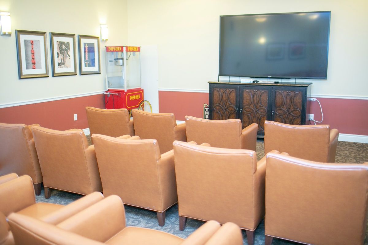 A cozy home theater setup with comfortable seating and a popcorn machine.