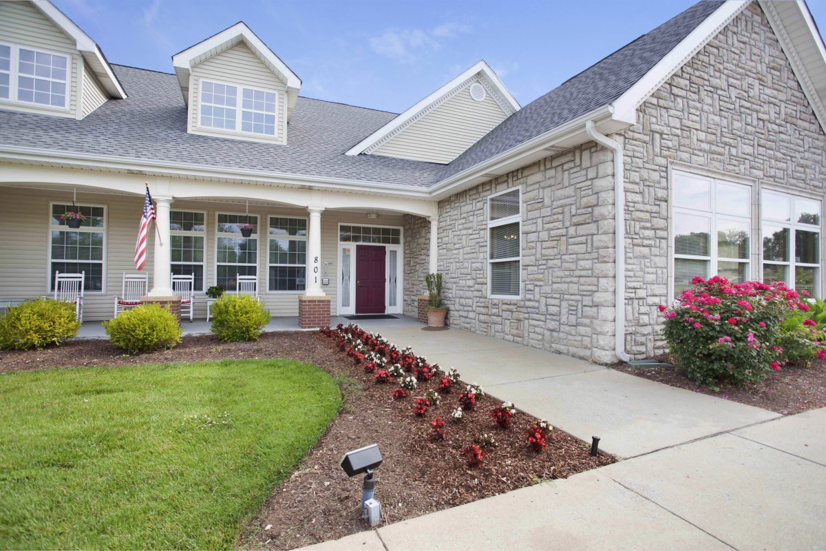 A charming house with a well-maintained front yard and garden bed.