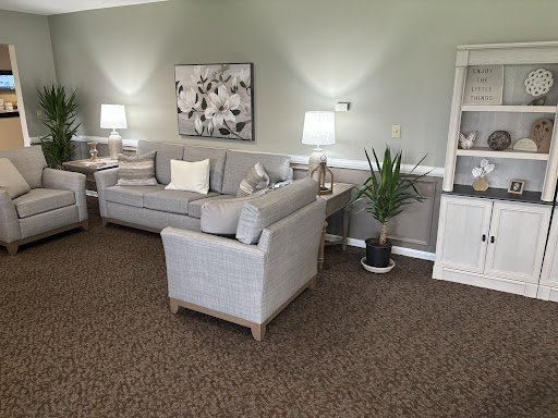 A cozy and inviting living room space featuring a comfortable sofa, decorative elements, and warm lighting.