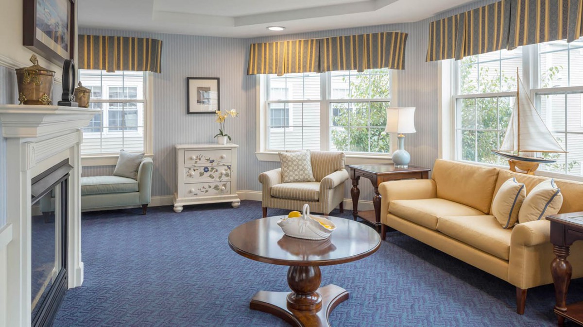 A cozy living room with comfortable seating and large windows letting in natural light.