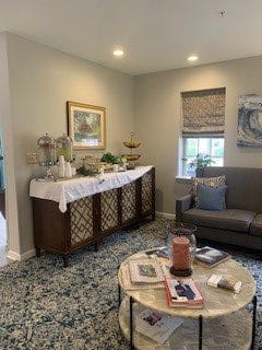 A cozy living room with a sofa, decorated sideboard, and coffee table.