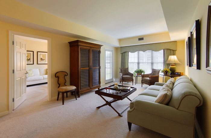 A spacious living room with elegant furniture and large windows.