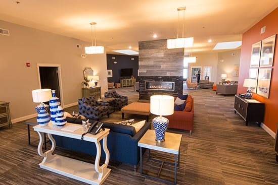 A modern and elegantly furnished lounge area with comfortable seating and ambient lighting.