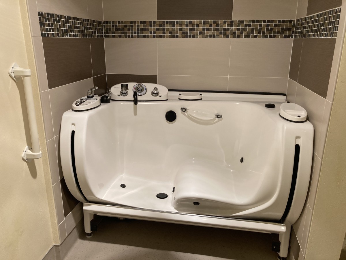 A modern hydrotherapy bathtub in a tiled bathroom setting.