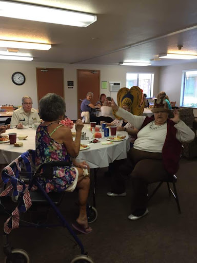 A lively gathering of seniors enjoying lunch and each other's company.