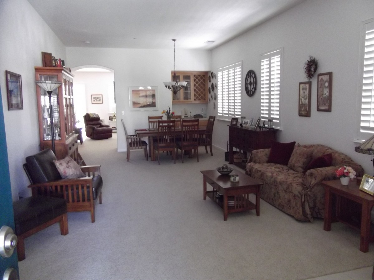 A spacious living and dining area featuring comfortable seating and elegant decor.