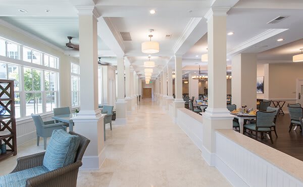 A spacious, modern hallway with elegant lighting and comfortable seating.