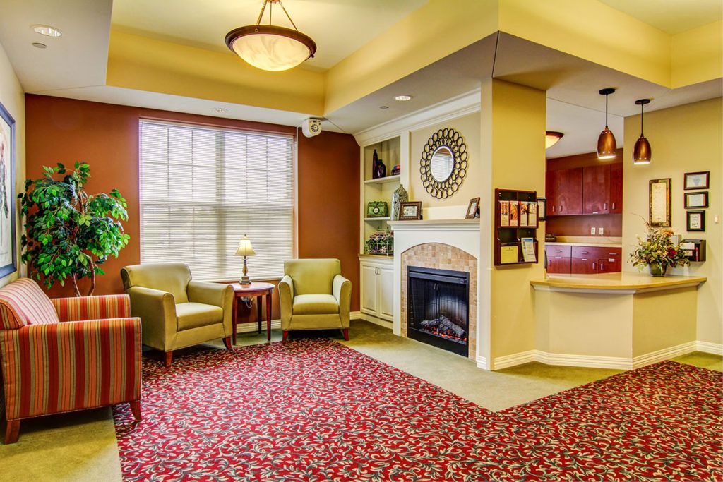 A cozy living room with comfortable seating, a fireplace, and warm decor.