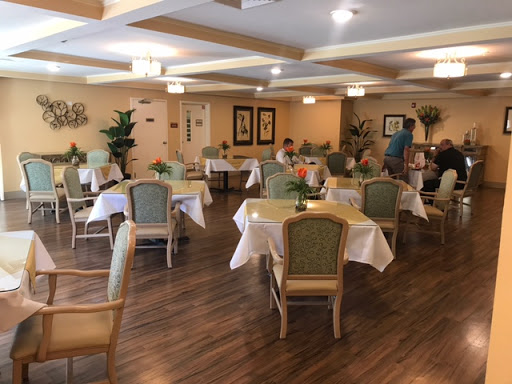 A cozy dining area with elegantly set tables and comfortable chairs, inviting guests to enjoy a meal.