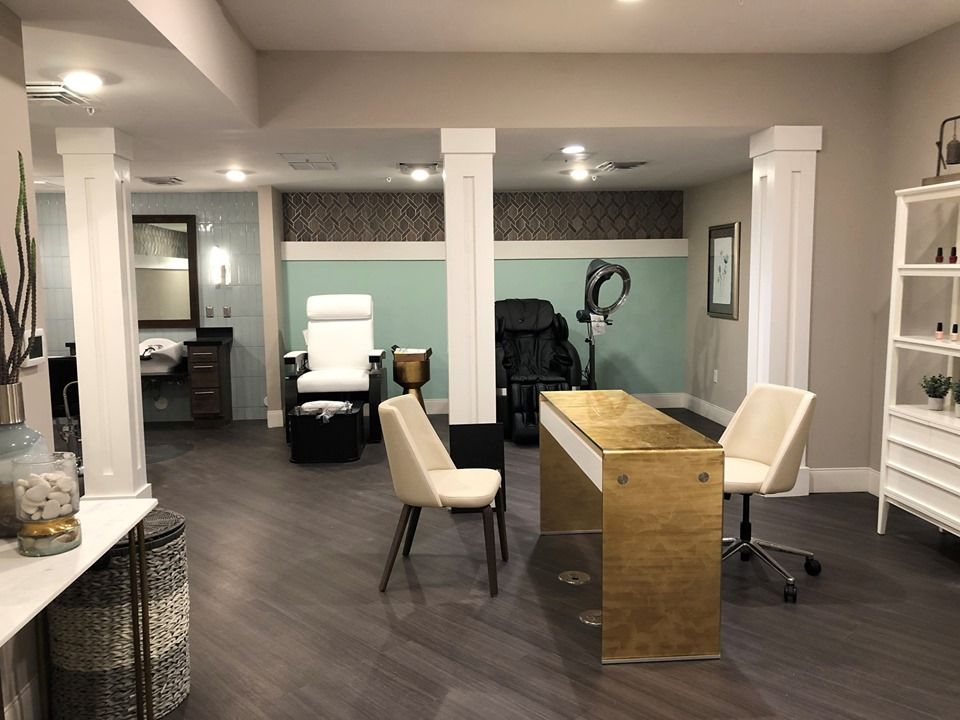 A modern office space with a desk and chairs, featuring sleek and stylish interior design.