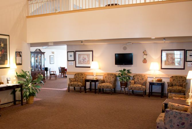A cozy lobby area with seating, plants, and decor.