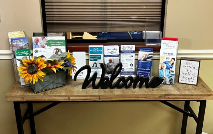 A welcoming setup with brochures and floral arrangement in a healthcare waiting area.
