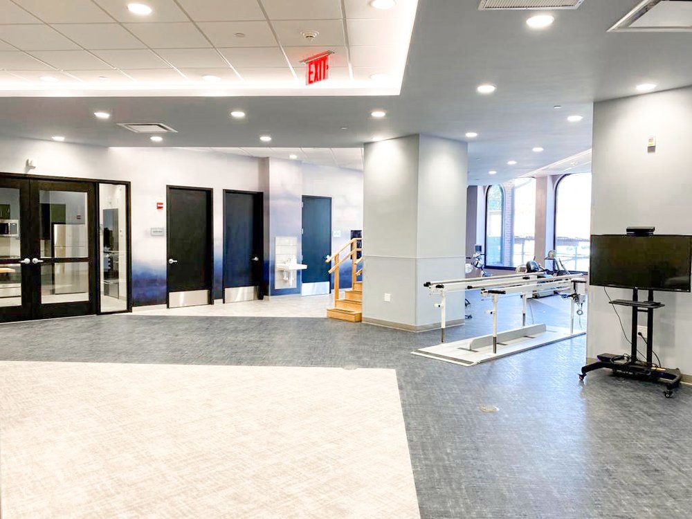 A modern gym interior with exercise equipment and spacious layout.