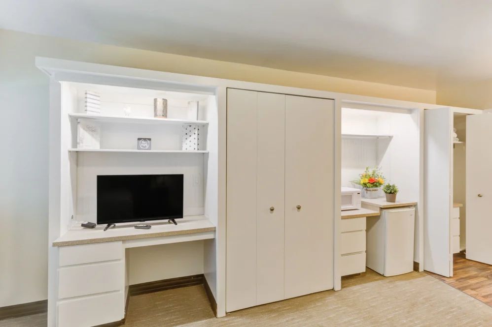 A modern and minimalist home office setup with ample storage.