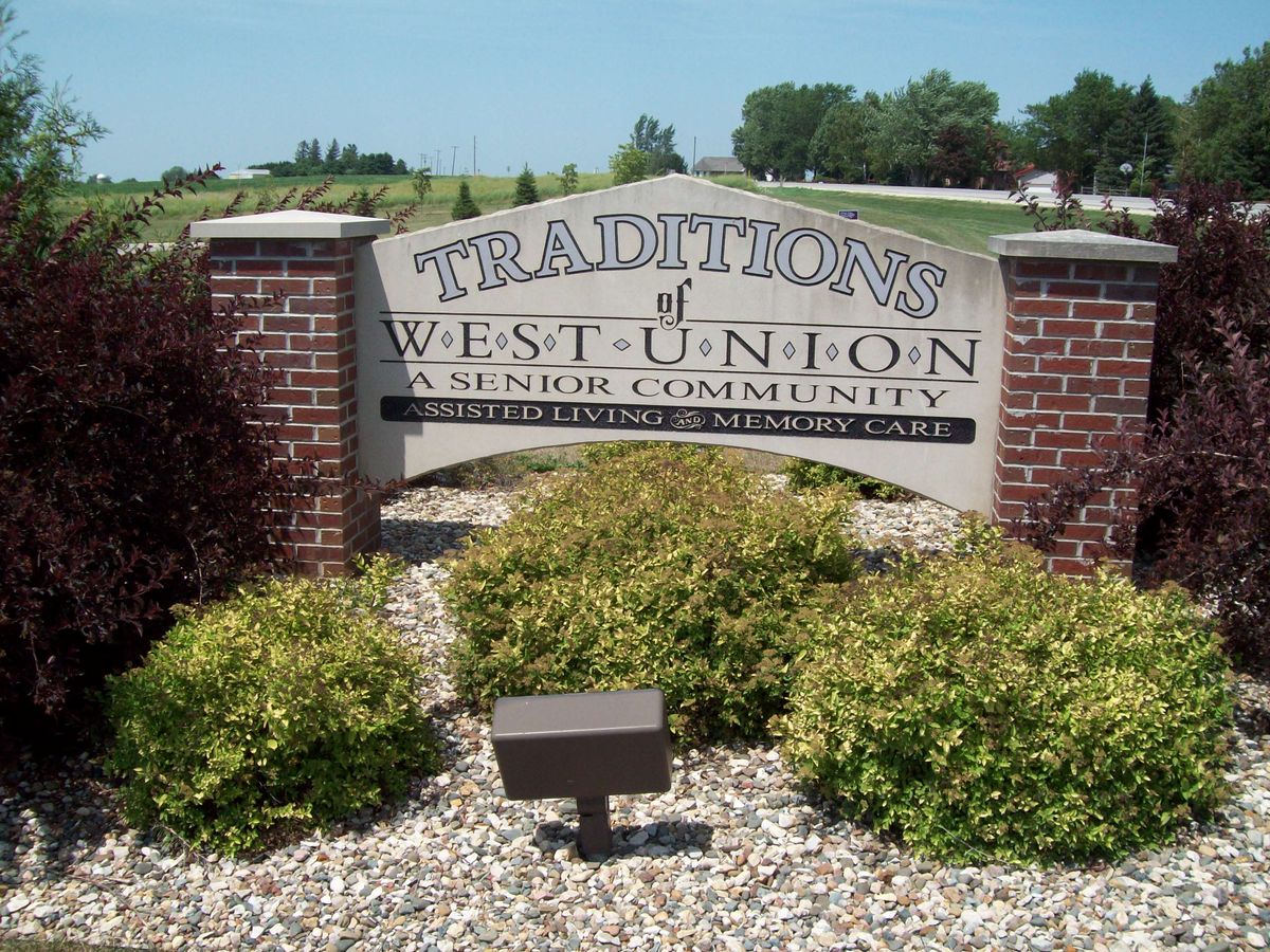 Entrance sign for Traditions of West Union surrounded by landscaping.