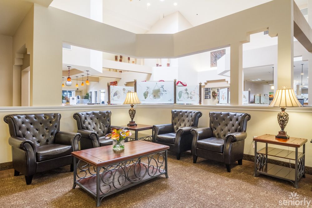 A cozy lobby area with armchairs and a coffee table, creating an inviting atmosphere.