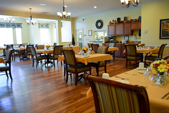 A well-arranged dining area with neatly set tables and chairs in a cozy indoor setting.