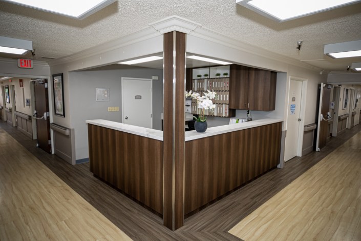 Modern reception area with wood paneling and a sleek counter design.