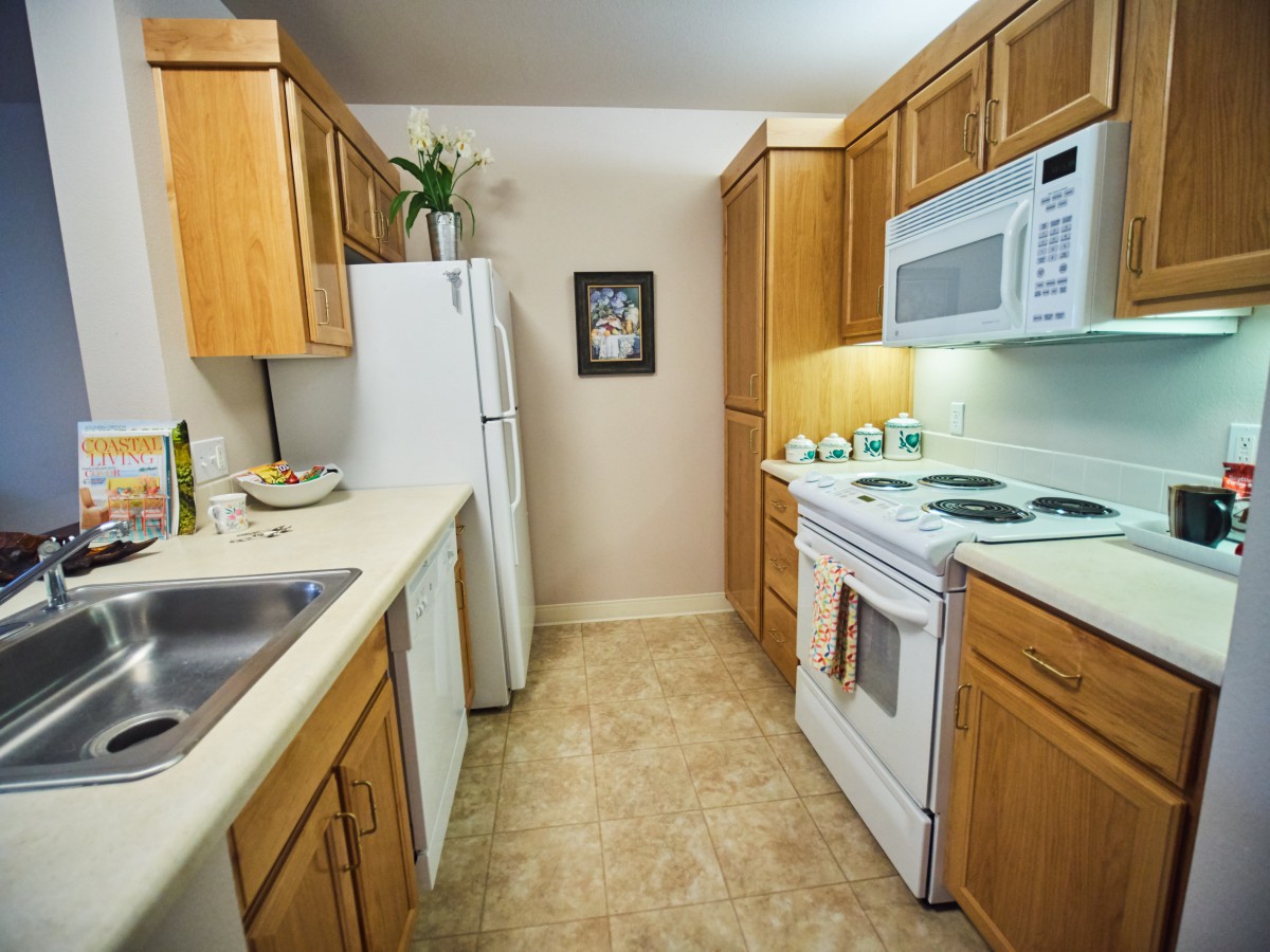 A tidy kitchen with wooden cabinets and modern appliances.
