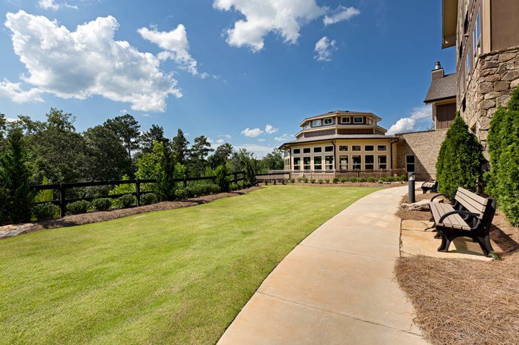 A scenic view of a modern building with a surrounding landscape and clear sky.