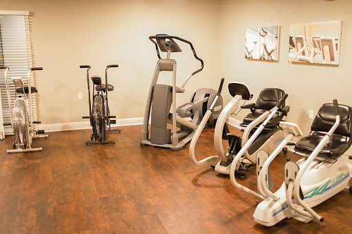 A well-equipped indoor gym area featuring various exercise machines.