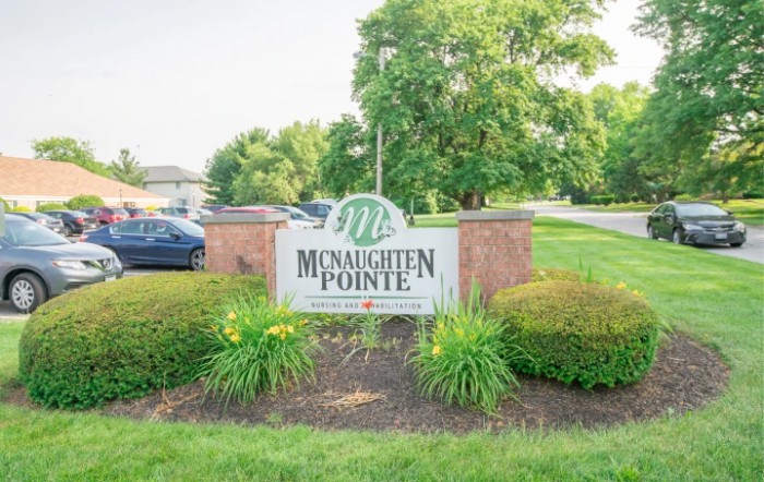 Entrance sign for McNaughten Pointe surrounded by well-maintained landscaping.