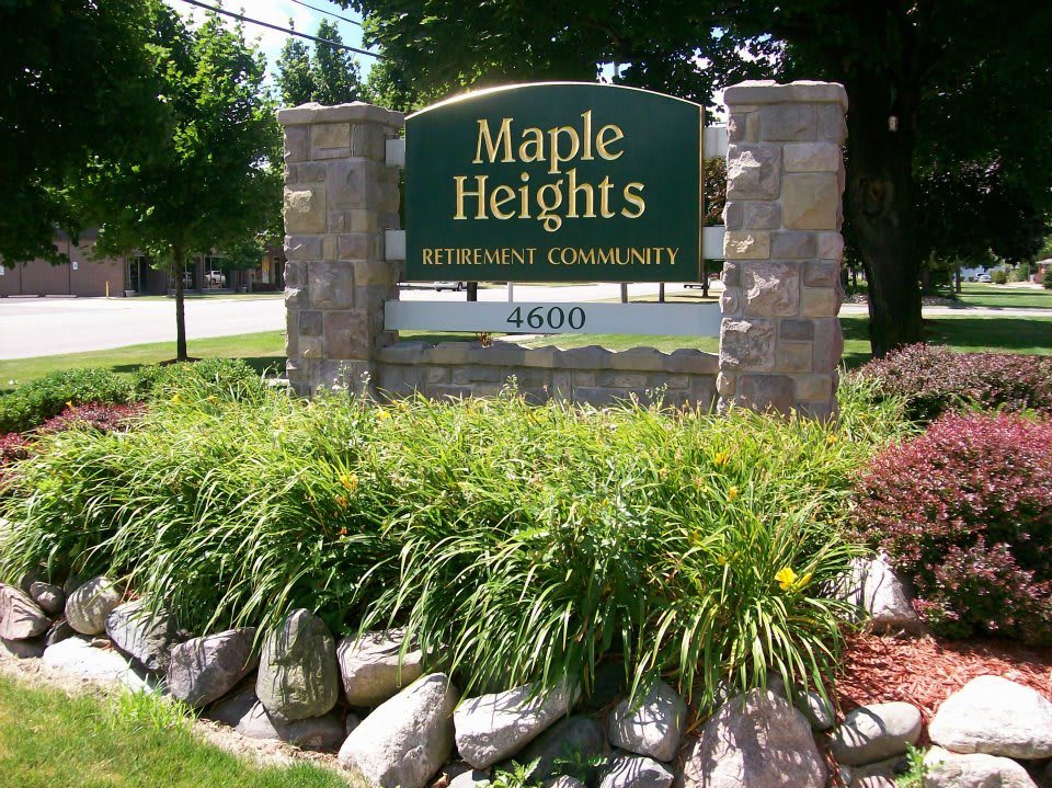 Sign for Maple Heights Retirement Community surrounded by landscaping.