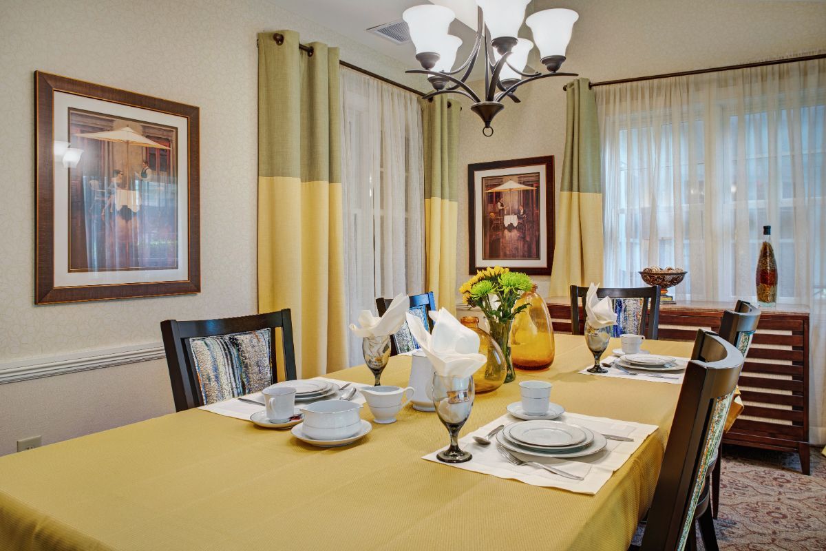 A well-set dining room table with elegant decor and place settings.