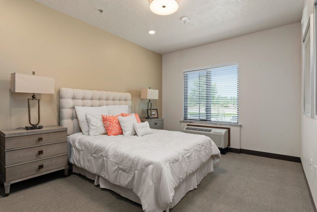 A cozy bedroom with a neatly made bed and soft lighting.