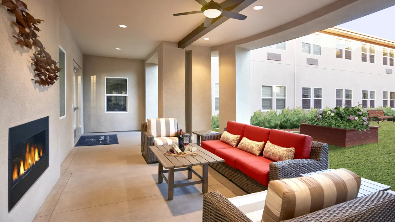 A cozy patio with comfortable seating and a red sofa.