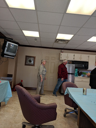 A casual gathering in a kitchen area with people interacting.