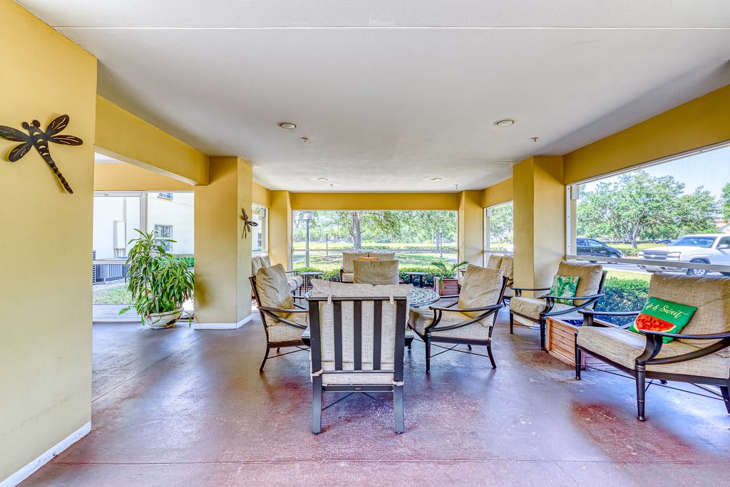 A spacious indoor patio area with comfortable seating and large windows.