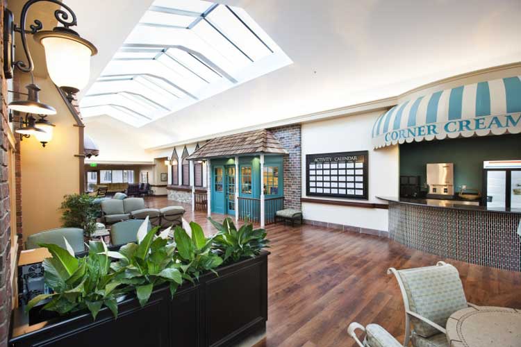 A modern interior space featuring a skylight, plants, and a comfortable waiting area.