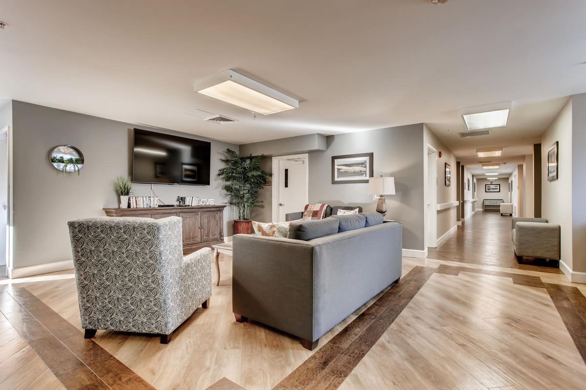 A modern lobby area with comfortable seating and a television.