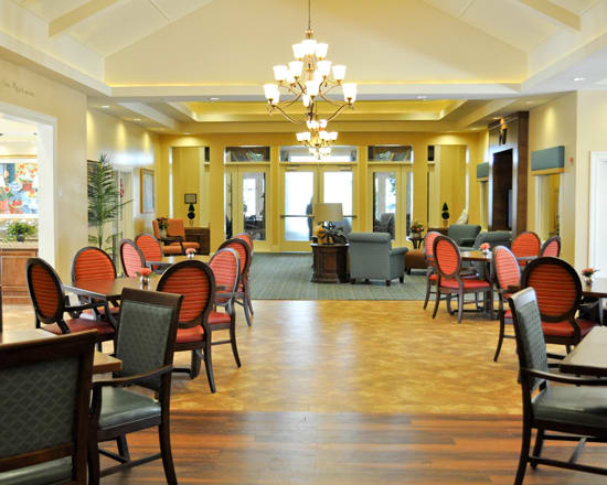 Elegant dining room with chandeliers and stylish furniture.